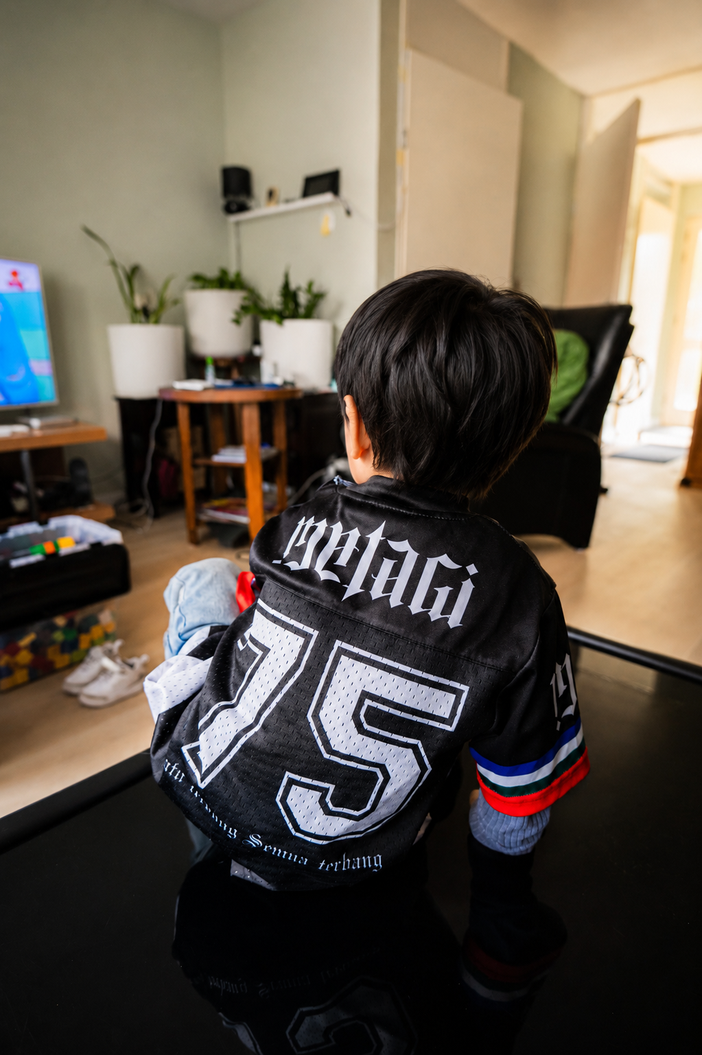 MATAGI Moluccan Kids Jersey Black — back view worn by child